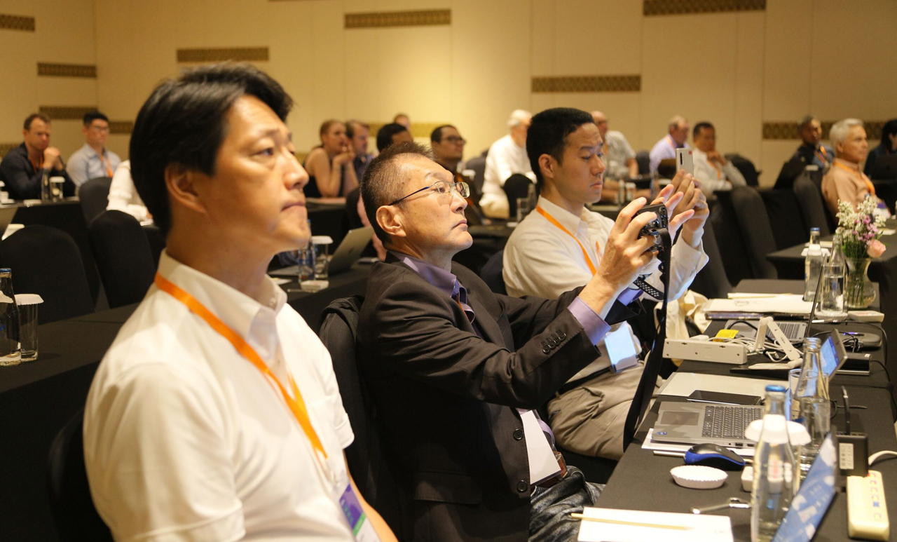 a man capturing the conference with his camera